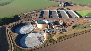 Overhead view of biogas digester tanks being built on farmland