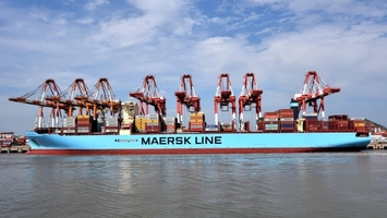 Maersk Line container ship docked at port with cargo cranes